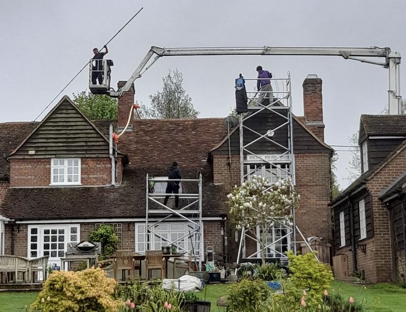 The Moss Cleaners using cherry picker and scaffolding to clean roof safely and professionally in Cheltenham, Gloucestershire